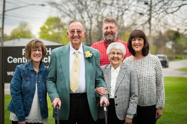 Jack Gaffney and his family pose in front of the building sign